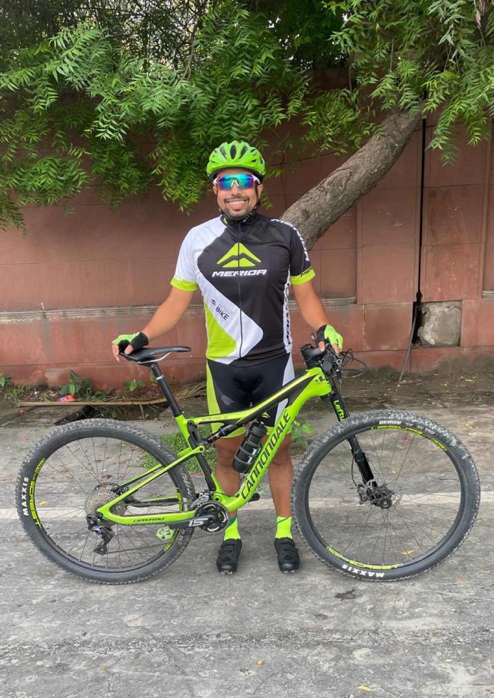 Sandeep in cycling kit beside his Cannondale mountain bike
